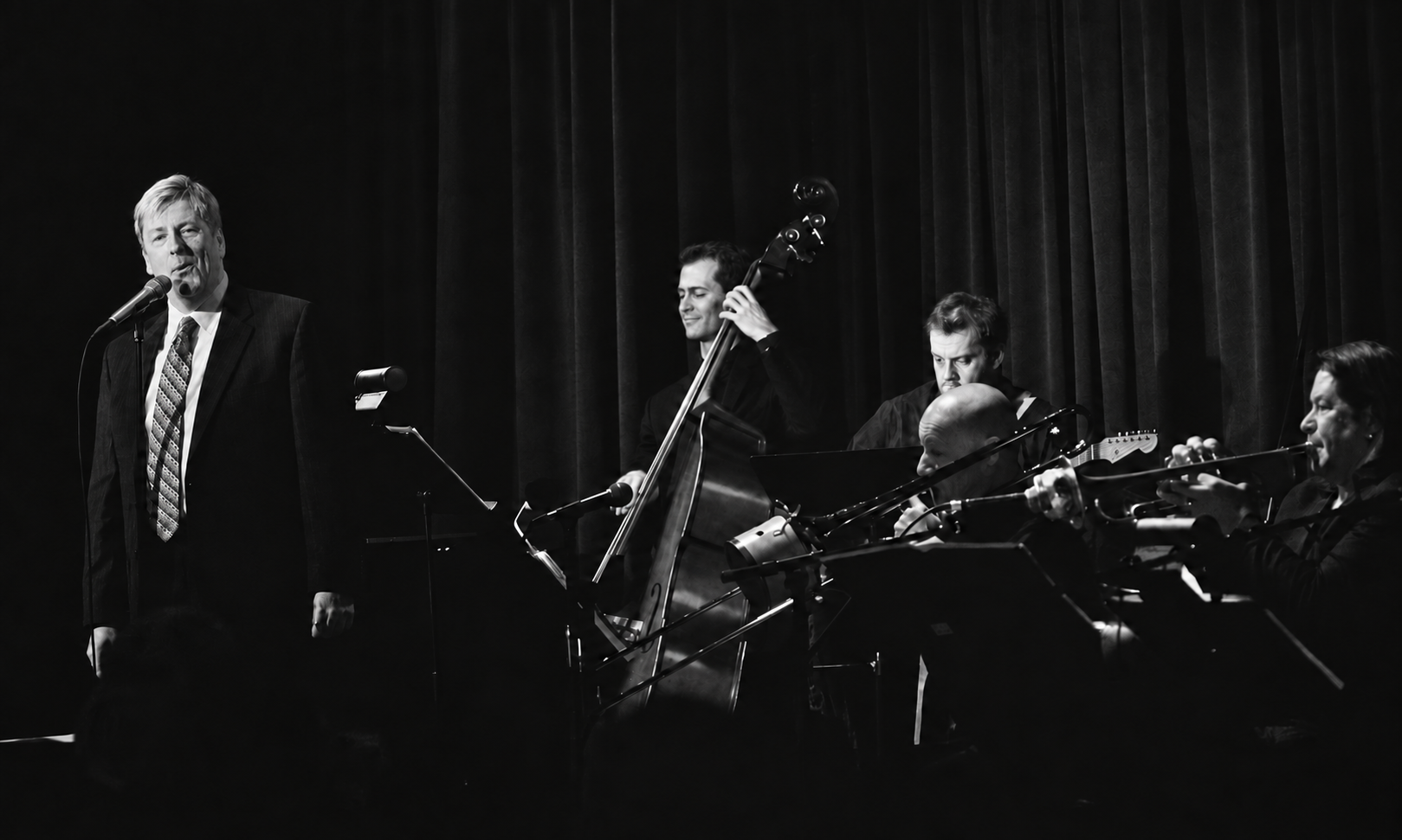 Russ Lorenson performing with his band, in black and white.